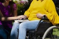 Woman in a wheelchair holding hands with her young daughter on her lap Royalty Free Stock Photo