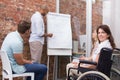 Woman in wheelchair smiling at camera during presentation Royalty Free Stock Photo