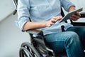 Woman in wheelchair using a tablet