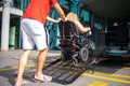 Disabled person on wheelchair using van ramp Royalty Free Stock Photo