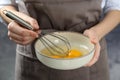Woman whisking eggs in bowl, closeup
