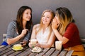 Woman whispering secret at friends ear, gossip Royalty Free Stock Photo