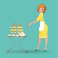 Woman in white apron serves cookies on trolley, girl waiter with dessert tray and service tea kettle, cups in yellow