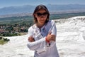 Woman in white on a background of calcium travertine