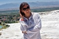 Woman in white on a background of calcium travertine