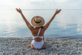 Woman white bikini beach tan. Happy woman in swimwear and hat on vacation. Summer travel holidays vacation on the sea Royalty Free Stock Photo