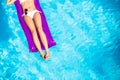 Woman in white bikini lying on air bed in pool Royalty Free Stock Photo