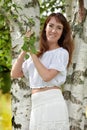 Woman in white by birch in summer Royalty Free Stock Photo