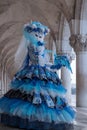 Portrait of woman looking back over her shoulder, under the arches at the Doges Palace, Venice, during the carnival