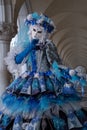 Close up of woman mask under the arches at the Doges Palace, Venice, Italy during the carnival