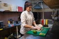 Woman in white chef prepares sushi restaurant Royalty Free Stock Photo