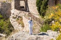 A woman in white on a cliff in the Siurana, Tarragona, Catalunya, Spain. Back view