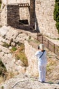 A woman in white on a cliff in the Siurana, Tarragona, Catalunya, Spain. Back view. Vertical