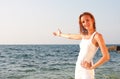 Woman in white cloth inviting to sea