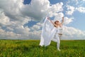 Woman in flower field with silk cloth in her hands Royalty Free Stock Photo