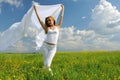 Woman in flower field with silk cloth in her hands Royalty Free Stock Photo