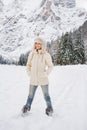 Woman in white coat and fur hat standing in winter outdoors Royalty Free Stock Photo