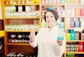 Woman in white coat promoting food additive goods in carton in d Royalty Free Stock Photo