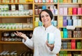 Woman in white coat promoting food additive goods in carton in d