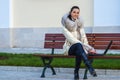 Woman in white coat sitting on bench Royalty Free Stock Photo