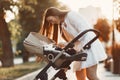 Woman in a white dress with child carriage Royalty Free Stock Photo