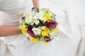 Woman in a white dress holding her wedding flowers Royalty Free Stock Photo