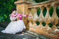 Woman in a white dress with a pink rifle plays airsoft Royalty Free Stock Photo