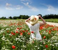 Happy Woman on field , red poppy flowers field blue cloudy sky summer sunny day