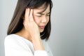 Woman in a white dress is touching head to show her headache. Causes may be caused by stress or migraine. Royalty Free Stock Photo