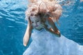 Woman in white dress under water pool. Royalty Free Stock Photo