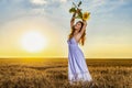 Woman In White Dress In A Wheat Field With A Sunflower Flower At Sunset