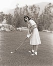 Woman in white gloves playing golf