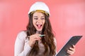 Woman in white hardhat writes information for project Royalty Free Stock Photo