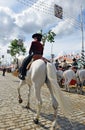 Woman on white horse at the fair in Seville, Andalusia, Spain