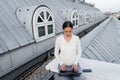 woman in white jumper typing on