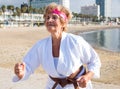 Old lady in kimono running on beach
