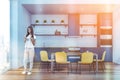 Woman in white kitchen with blue countertops Royalty Free Stock Photo