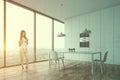 Woman in white kitchen with table