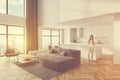 Woman in white living room and kitchen corner Royalty Free Stock Photo