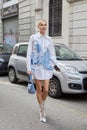 Woman with white, long shirt with blue designs before Iceberg fashion show, Milan Fashion Week