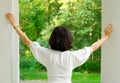 Woman in white looking out window Royalty Free Stock Photo