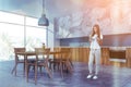 Woman in white marble and blue kitchen Royalty Free Stock Photo