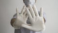 Woman with a white medical mask and latex glove shows the symbol STOP with both hands. Stopping the disease. Royalty Free Stock Photo