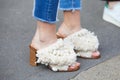 Woman with white open shoes with fringes before Salvatore Ferragamo fashion show, Milan Fashion Week street