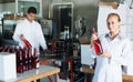 female packing bottles on winery .