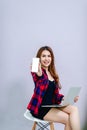 Woman and the white screen phone place the space and have a computer ready to work all the time