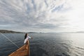 Woman in white shirt enjoying private tour on luxury wooden yacht. Ocean view Royalty Free Stock Photo