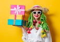 Woman in white shirt and hat with fresh springtime tulips and gift box Royalty Free Stock Photo