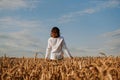 A woman in white shirt in rye field. View from the back. The concept of harmony Royalty Free Stock Photo