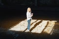 Woman in a white shirt takes notes in a notebook, looks into the camera Royalty Free Stock Photo